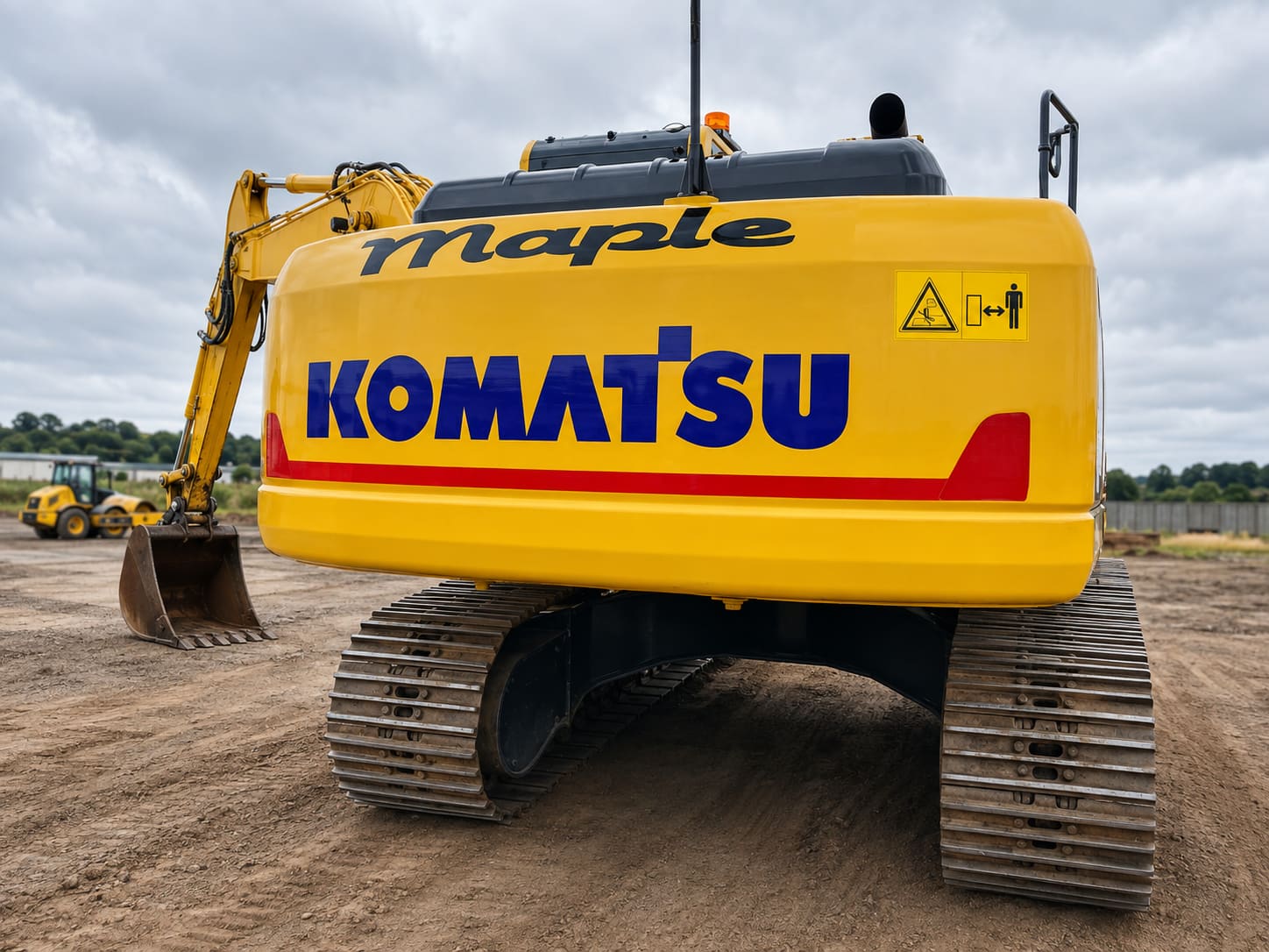 Komatsu excavator with branded Maple decal signage